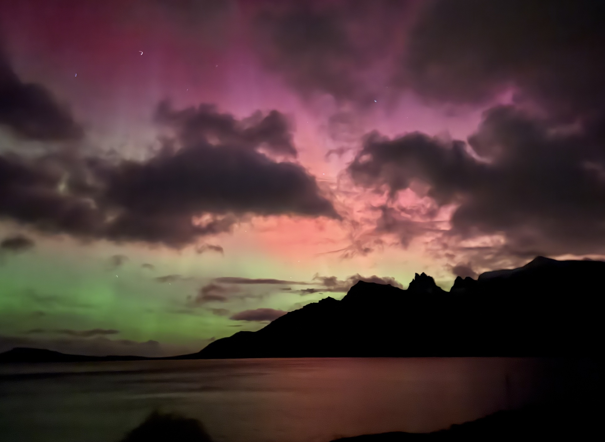 Northern lights over the fjord and mountain line