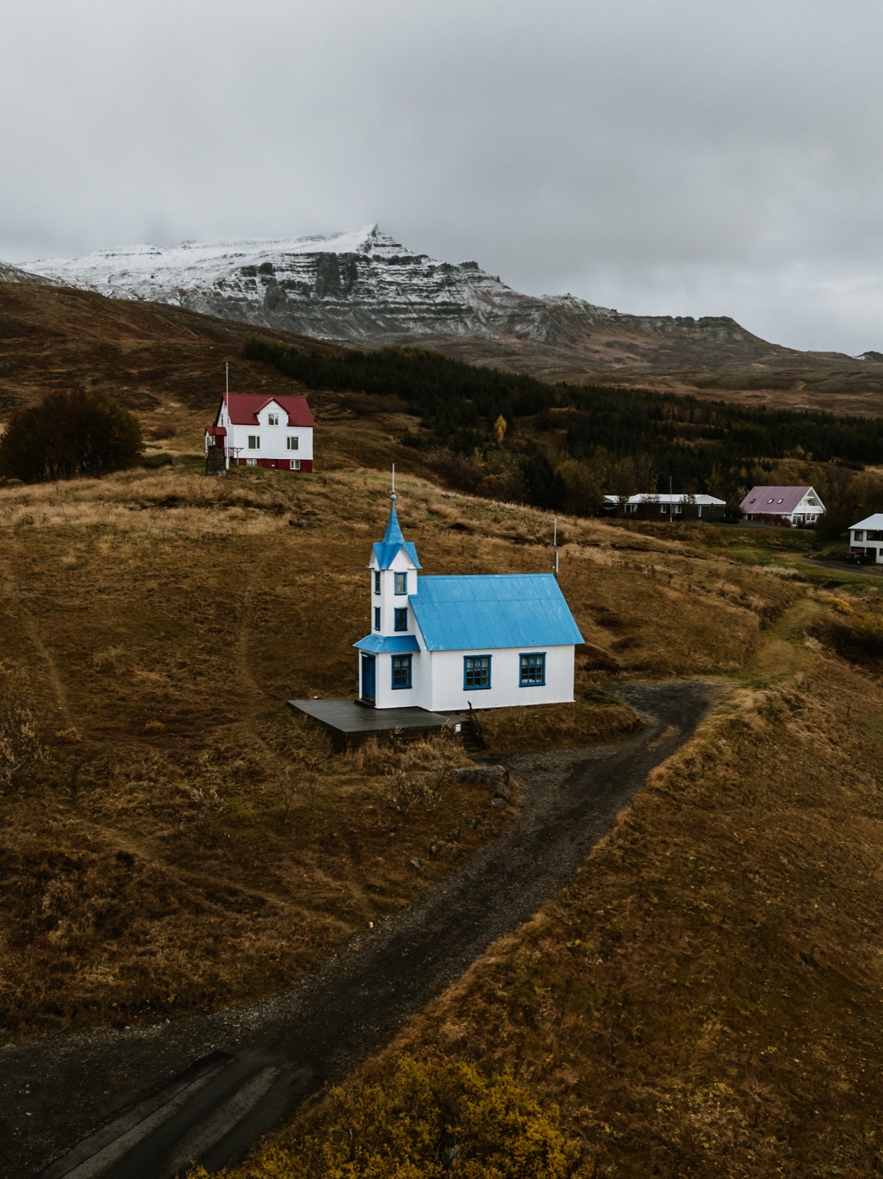 Closer aerial view of Tiny Church with the mountain behind it