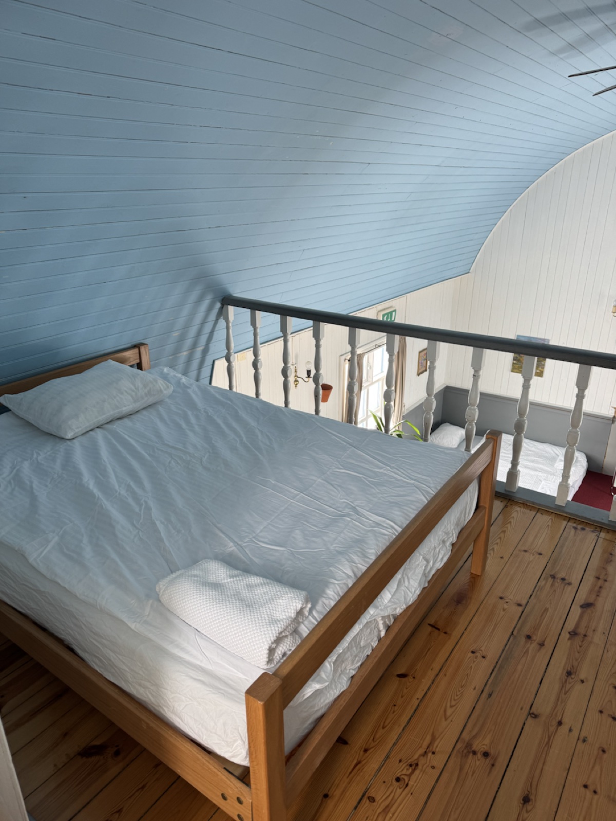 Mezzanine bed under the blue ceiling inside Tiny Church